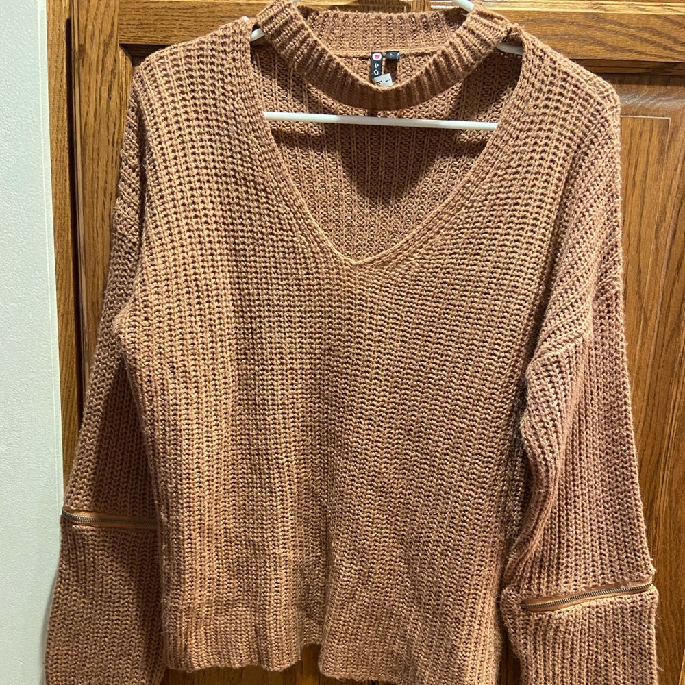 Sweater with scoop neck cutout and zippers on arms